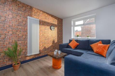 Bright and stylish living room featuring a mode...