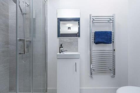 Bright and modern bathroom suite featuring a sl...
