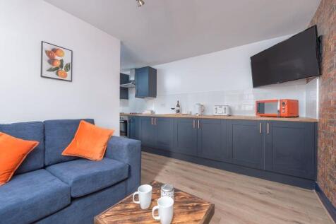 A modern living room featuring a comfortable bl...