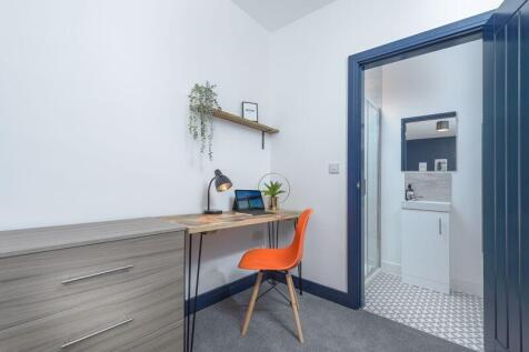 A bright and tidy communal workspace featuring ...