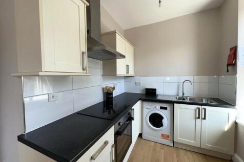 Bright and modern kitchen featuring sleek black...