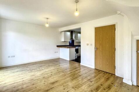 Bright and spacious living room with wood floor...