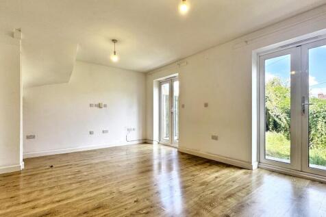 Bright and spacious living room featuring large...