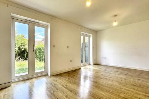 Bright and spacious living room featuring large...