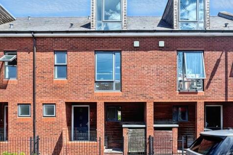 A charming brick terraced house with large wind...