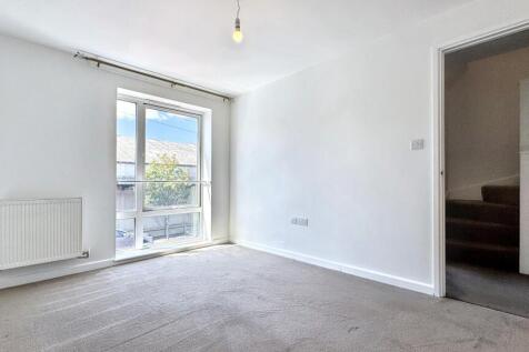 A bright and clean living room featuring a larg...