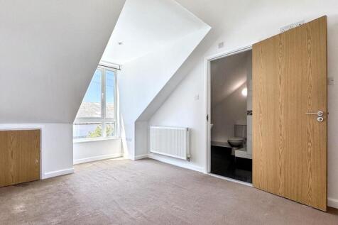 A bright and tidy small room featuring a white ...