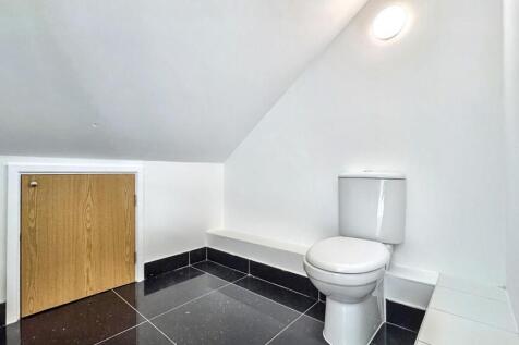 A clean and modern single toilet room with slee...