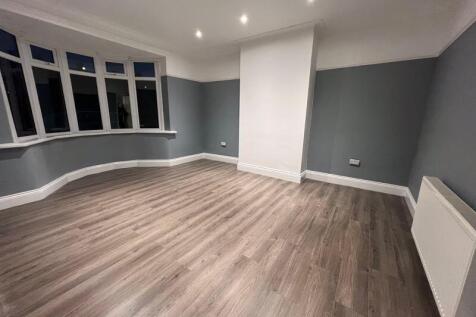 Spacious and modern master bedroom featuring la...