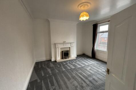 Bright and spacious master bedroom featuring a ...