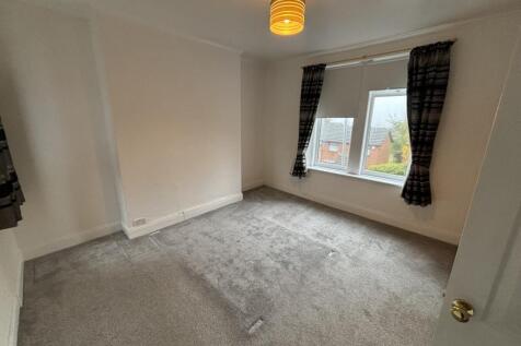 A bright and clean double bedroom featuring a l...