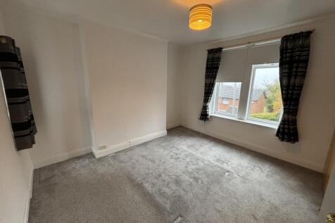 A bright and clean double bedroom featuring two...
