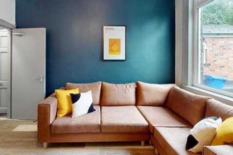 A stylish living room featuring a spacious L-sh...