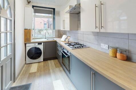 Bright, modern kitchen featuring sleek cabinetr...