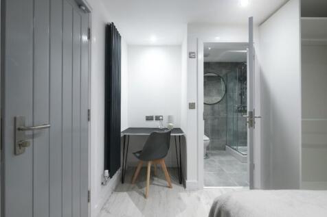 This inviting double bedroom features a stylish...