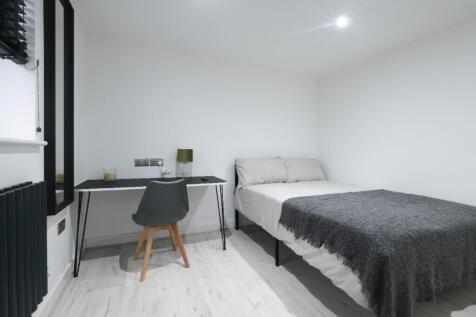 Cozy double bedroom featuring a comfortable bed...