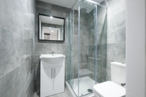 A modern bathroom featuring a sleek shower, sty...
