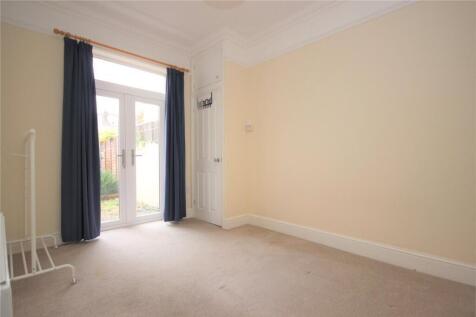 A bright double bedroom featuring neutral walls...