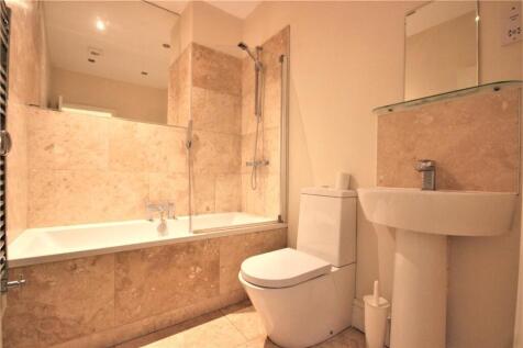 A modern bathroom suite featuring a bathtub wit...
