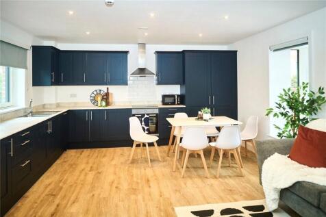 Bright and modern kitchen featuring sleek dark ...