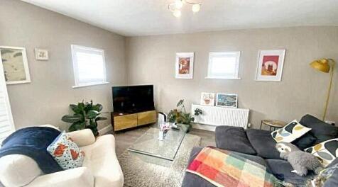 A cozy living room featuring a comfortable sofa...