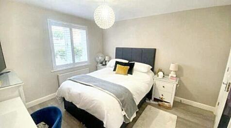 Bright and cozy double bedroom featuring a comf...