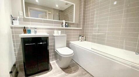 A modern bathroom suite featuring a clean batht...