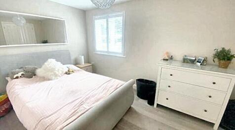 Bright and neat double bedroom featuring a comf...