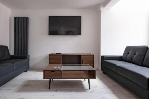 A modern living room featuring stylish furnitur...
