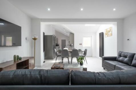 A modern and inviting living room featuring sle...
