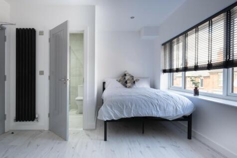 This stylish double bedroom features sleek deco...