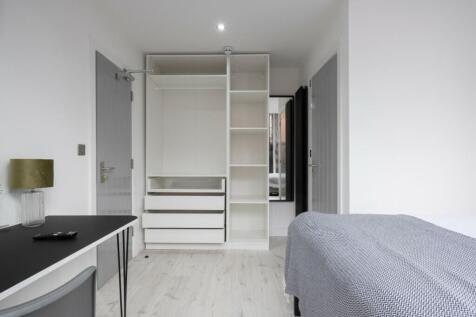 Spacious double bedroom featuring ample storage...