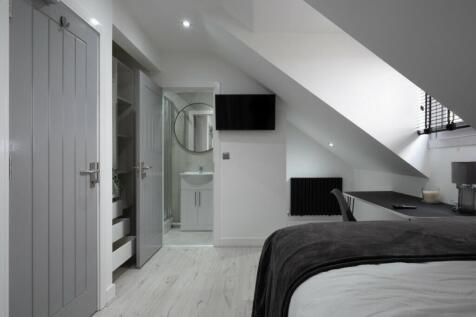 This stylish double bedroom offers a cozy retre...