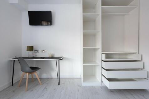 This modern double bedroom features a sleek des...