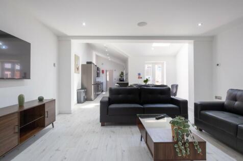 Spacious and contemporary living room featuring...