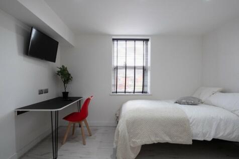 This stylish double bedroom features a comforta...
