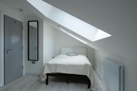 This charming double bedroom features a cozy de...