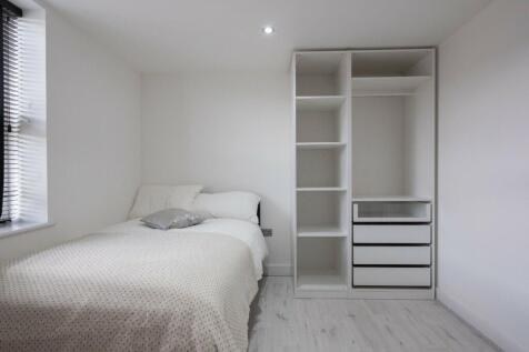 This modern double bedroom features a cozy layo...