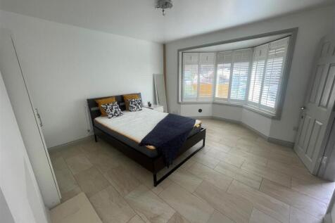 A spacious master bedroom featuring a large dou...