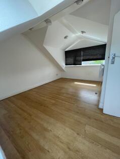 A clean and well-maintained room featuring ligh...