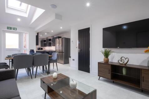 A stylish and spacious living room featuring mo...