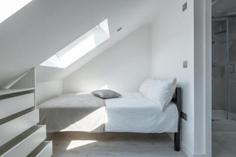 Bright and airy double bedroom featuring a cozy...