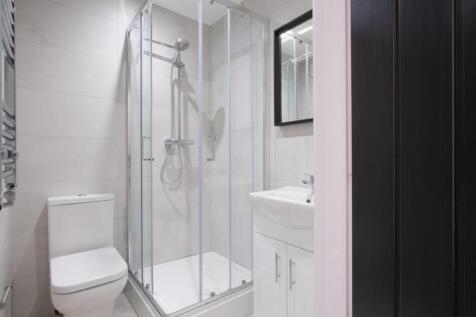 Modern bathroom featuring a sleek shower enclos...