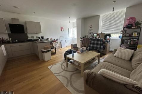 A cozy and well-furnished living room featuring...
