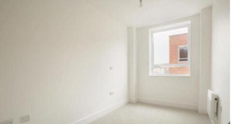 A bright and clean single bedroom with a large ...