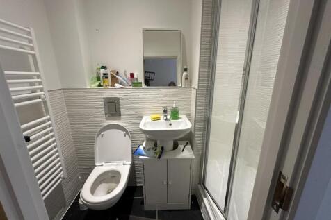 A clean and modern single toilet room featuring...