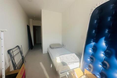 A bright and simple narrow room featuring a sin...