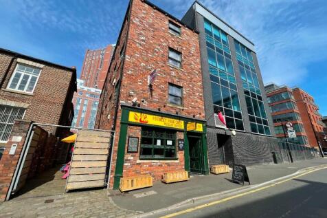 A bright and clear street view of a charming te...