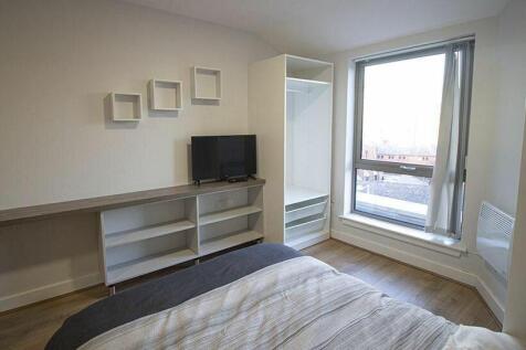 A bright and tidy double bedroom featuring a la...