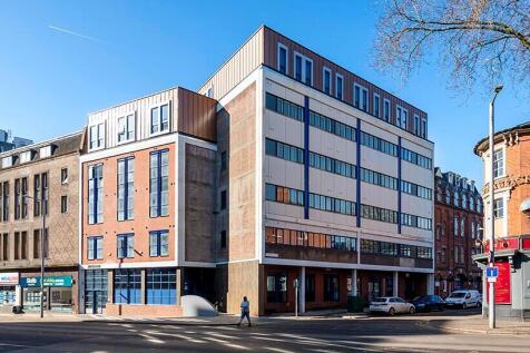 Modern multi-story building with clean brick an...